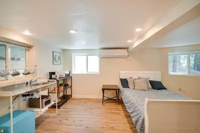 a bedroom with a bed and a desk and a sink at Cozy Crestline Getaway about 2 Mi to Lake Gregory in Crestline