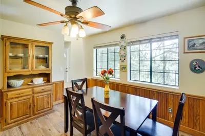 a dining room with a table and a ceiling fan at All-Season Crestline Escape - 2 Mi to Lake! in Crestline