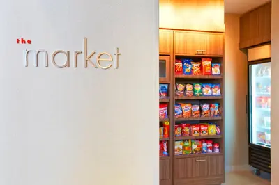 a grocery store with a refrigerator and a shelf of food at Residence Inn by Marriott Los Angeles Redondo Beach in Redondo Beach