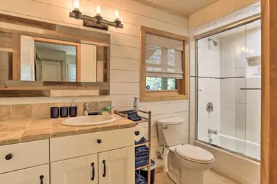 a bathroom with a toilet and a sink and a shower at Steps to Lake Cabin with Deck in Lake Arrowhead in Lake Arrowhead