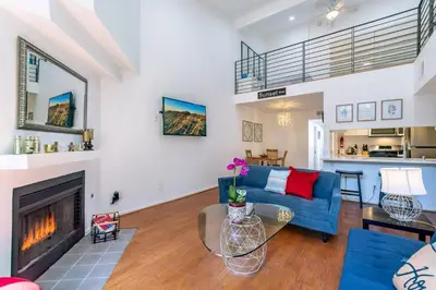 a living room with a blue couch and a fireplace at Franklin Hollywood Bowl Loft in Los Angeles