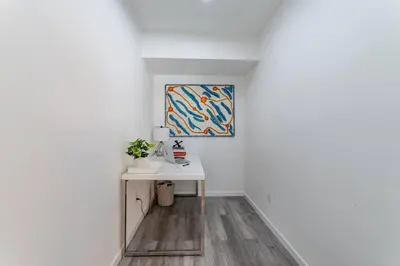 a hallway with a desk and a painting on the wall at Franklin Hollywood Bowl Loft in Los Angeles
