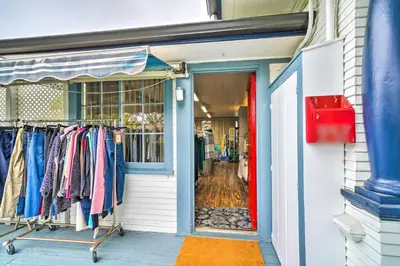 a store front with a rack of clothes in front of a door at Cozy Carpinteria Apartment Walkable Location in Carpinteria