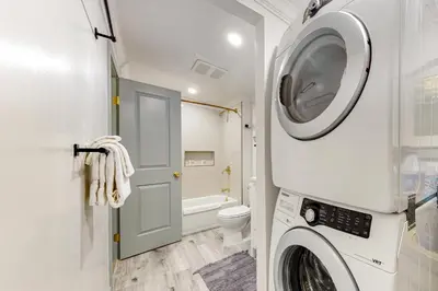 a washing machine in a bathroom with a toilet at Top Town Retreat in Crestline