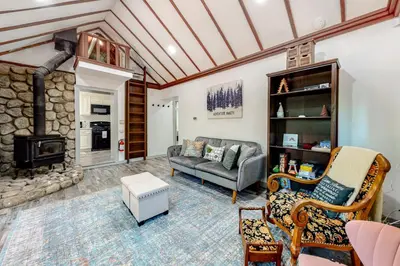 a living room with a couch and a fireplace at Top Town Retreat in Crestline