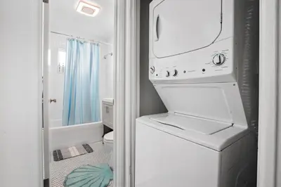 a white washer and dryer in a bathroom at The Green Haven, 1 Minute Walk to the Beach and Restaurants, King Beds, Beach Amenities in Ventura
