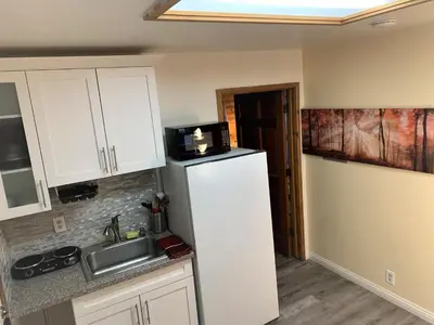a kitchen with a refrigerator and a sink at Cozy Lake-View Lodge Near Village in Big Bear Lake