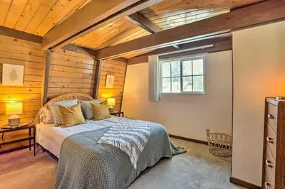 a bedroom with a bed and a window at Pet-Friendly Cottage, Walk From Big Bear Village! in Big Bear Lake