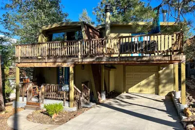 a house with a deck and a garage at Pet-Friendly Cottage, Walk From Big Bear Village! in Big Bear Lake