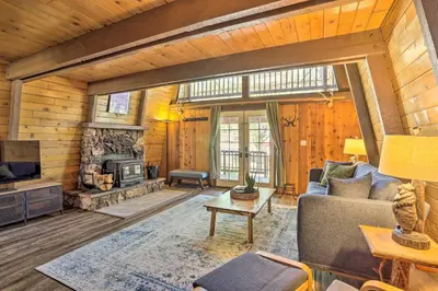 a living room with a couch and a fireplace at Pet-Friendly Cottage, Walk From Big Bear Village! in Big Bear Lake
