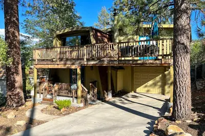 a tree house with a deck and a garage at Pet-Friendly Cottage, Walk From Big Bear Village! in Big Bear Lake