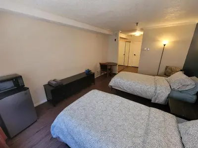 a hotel room with two beds and a television at (A11) Lovely Double Bed Unit in Los Angeles