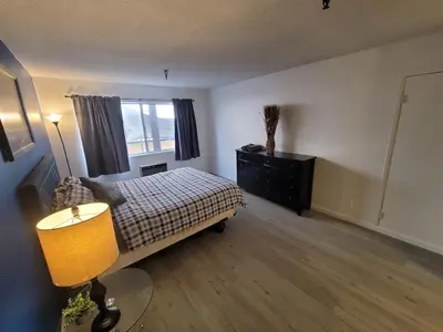 a bedroom with a bed and a dresser and a window at (A13) Cozy 1 Bedroom Studio with Private Bath in Los Angeles