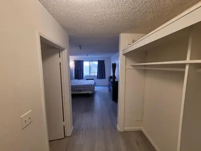 an empty room with a closet and a bedroom at (A13) Cozy 1 Bedroom Studio with Private Bath in Los Angeles