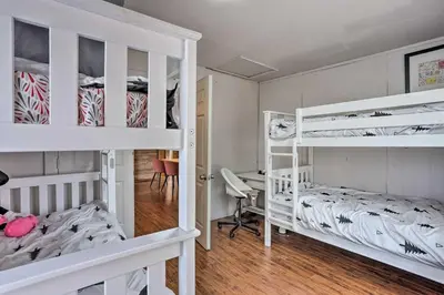 a bedroom with two bunk beds and a desk at Big Bear Cabin Close to Lake, Trails and Village! in Big Bear Lake