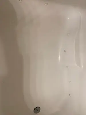 a white bath tub with a drain in it at LuxHome Suites in Mansion in Riverside