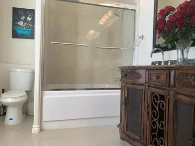 a bathroom with a shower and a toilet and a sink at LuxHome Suites in Mansion in Riverside