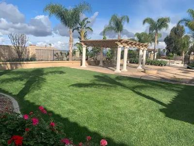 a garden with a gazebo and some flowers at LuxHome Suites in Mansion in Riverside