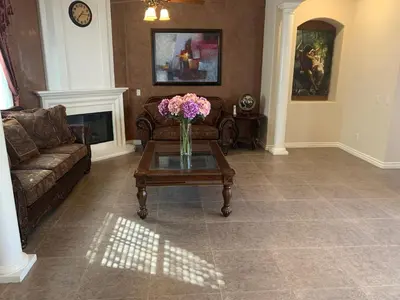 a living room with a vase of flowers on a coffee table at LuxHome Suites in Mansion in Riverside