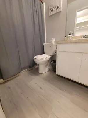 a bathroom with a toilet and a sink at Deluxe Hotel Style Unit in Los Angeles