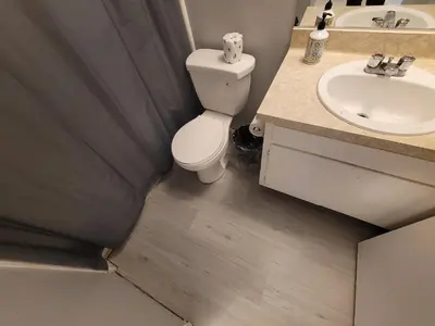 a bathroom with a toilet and a sink at Deluxe Hotel Style Unit in Los Angeles