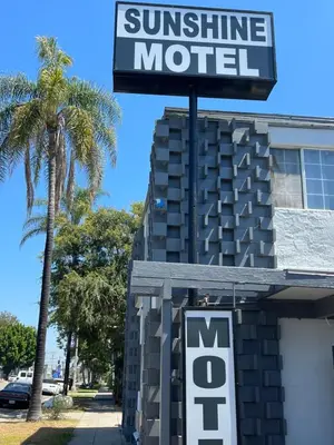 a sign that reads sunshine motel in front of a building at Sunshine Motel in Long Beach