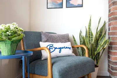 a blue chair with a pillow with the word boyfriend at Bayview Bungalow - Cabin with Hot Tub One Block from Big Bear Lake! in Big Bear Lake