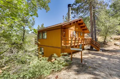 a tiny house in the woods with a staircase at Snow Valley Hideaway Arrowbear Lake Retreat in Arrowbear Lake