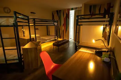 a room with two bunk beds and a table and a chair at Bposhtels Anaheim in Anaheim