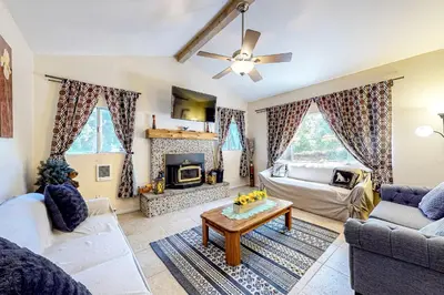 a living room with a couch and a table at Treelands Lodge in Crestline