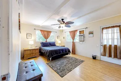 a bedroom with a bed and a ceiling fan at Treelands Lodge in Crestline