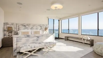 a bedroom with a bed and a view of the ocean at Matador by AvantStay Ocean Front Malibu Pad w Rooftop Patio in Topanga
