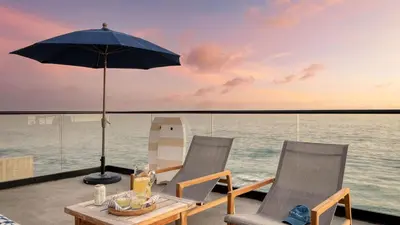 two chairs and a table with an umbrella on a boat at Matador by AvantStay Ocean Front Malibu Pad w Rooftop Patio in Topanga