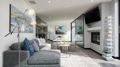 a living room with two couches and a tv at Matador by AvantStay Ocean Front Malibu Pad w Rooftop Patio in Topanga