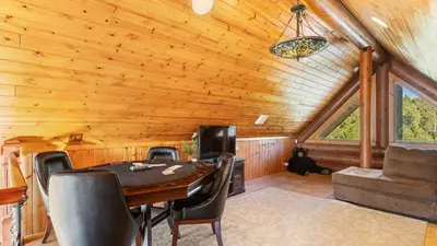 a dining room with a table and chairs in a cabin at 0.5mi to the Lake Deck w Views Poker Table Eagle Ridge Retreat by AvantStay in Big Bear Lake