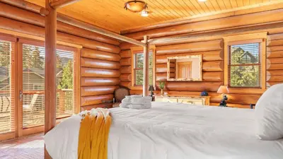 a bedroom with a large bed in a log cabin at 0.5mi to the Lake Deck w Views Poker Table Eagle Ridge Retreat by AvantStay in Big Bear Lake