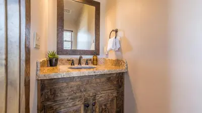 a bathroom with a sink and a mirror at Lakefront Lodge by AvantStay Direct Access to Big Bear Lake Hot Tub Views in Big Bear Lake