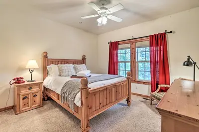 a bedroom with a bed and a ceiling fan at Spacious Lake Arrowhead Home with Putting Green in Lake Arrowhead