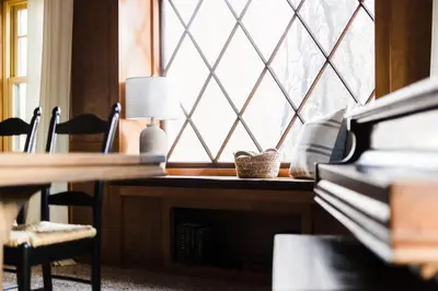 a desk with a lamp in front of a window at Walk to the Lake Sand Volleyball Court Pool Table Deck Gambler by AvantStay in Big Bear Lake