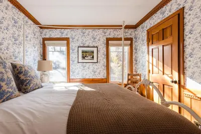 a bedroom with a bed with blue and white wallpaper at Walk to the Lake Sand Volleyball Court Pool Table Deck Gambler by AvantStay in Big Bear Lake