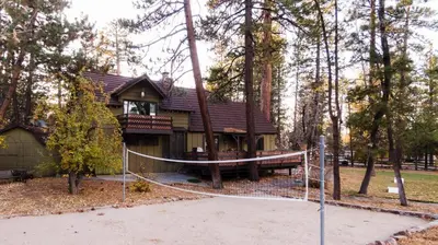 a house with a net in front of it at Walk to the Lake Sand Volleyball Court Pool Table Deck Gambler by AvantStay in Big Bear Lake