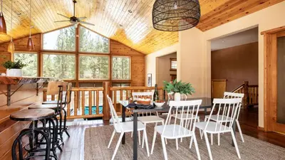 a dining room with a table and chairs at Bernard by AvantStay Luxurious Cabin in Big Bear w Hot Tub Pool Table in Big Bear Lake