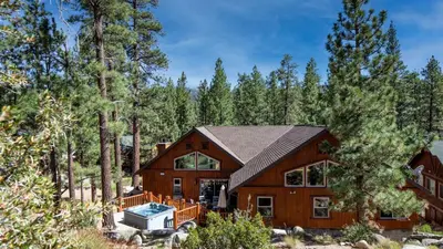 a house in the woods with a pool at Bernard by AvantStay Luxurious Cabin in Big Bear w Hot Tub Pool Table in Big Bear Lake