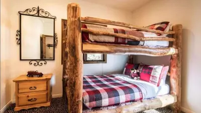 a bedroom with two bunk beds and a mirror at Big Bear Castle by AvantStay Private Home in Great Big Bear Location w Hot Tub in Big Bear Lake