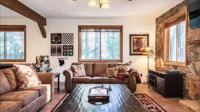 a living room with a couch and a table at Big Bear Castle by AvantStay Private Home in Great Big Bear Location w Hot Tub in Big Bear Lake