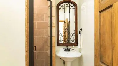 a bathroom with a sink and a mirror at Big Bear Castle by AvantStay Private Home in Great Big Bear Location w Hot Tub in Big Bear Lake