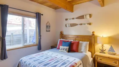 a bedroom with a bed and a window at 50 yards to Lake Boulder Bay • Pool Table Lakeside in Bearadise by AvantStay in Big Bear Lake