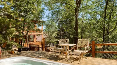 a deck with a table and chairs next to a pool at Zen Den by AvantStay Entertainers Home in Ideal Big Bear Location w Hot Tub in Big Bear Lake