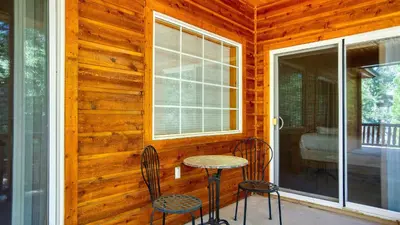 a porch with two chairs and a table and a window at Zen Den by AvantStay Entertainers Home in Ideal Big Bear Location w Hot Tub in Big Bear Lake