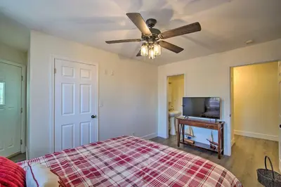 a bedroom with a bed and a ceiling fan at Relaxing Lake Arrowhead Home about 1 Mi to Lake! in Lake Arrowhead
